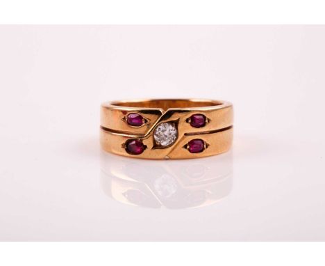 A two row ruby and diamond ring; the central round brilliant cut diamond in stylised crossover mount set with four oval cut r