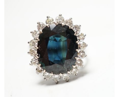 An 18ct, sapphire and diamond set oval cluster ring, size L, gross weight 5.7 grams.