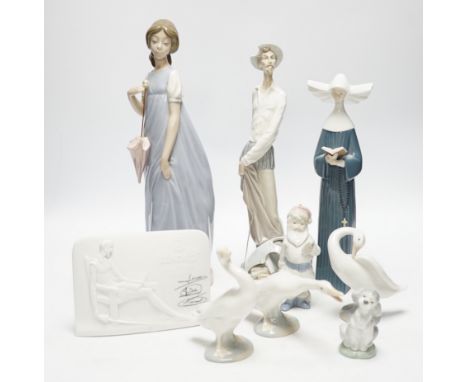 Twelve Lladro figures including a dog and three ducks, a plaque and two cups together ith three Nao figures, tallest figure 3