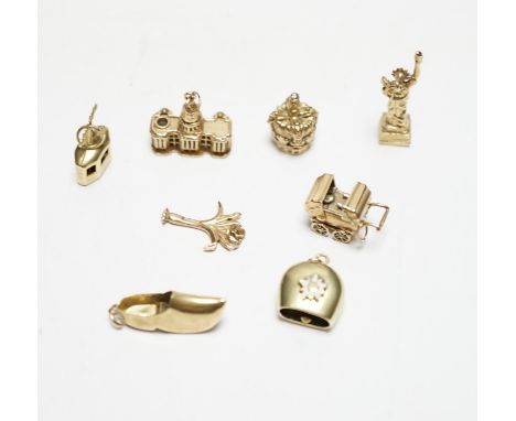A 585 'Cable car' charm, 1.4 grams, three 9ct gold charms, 9.9 grams and four other yellow metal charms, one with enamel, gro