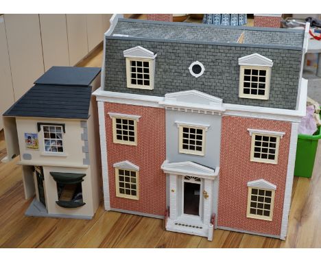 A modern Georgian style dolls house, with two front opening doors, containing six rooms with furnishings, figures, and electr