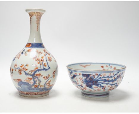 An 18th century Japanese Imari sake flask and a Chinese clobbered blue and white bowl (a.f), tallest 20cm