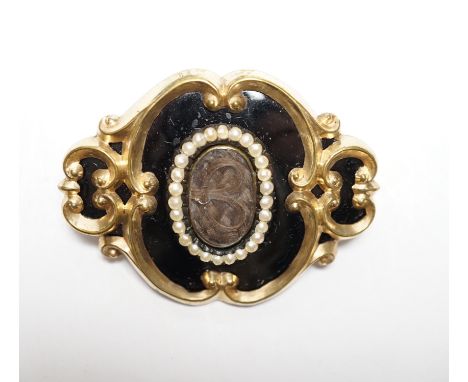 A Victorian yellow metal, black enamel and seed pearl set mourning brooch, 47mm.