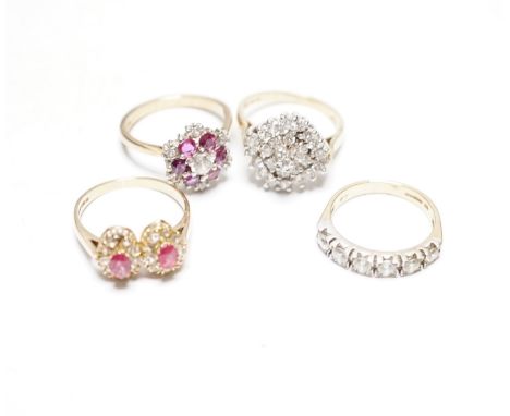 A modern 9ct gold, ruby and simulated diamond cluster set flower head ring, size N and three other assorted 9ct rings includi