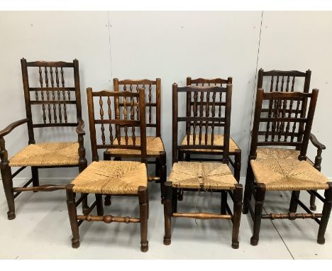 A harlequin set of seven 19th century Lancashire rush seat ladder back dining chairs, two with arms