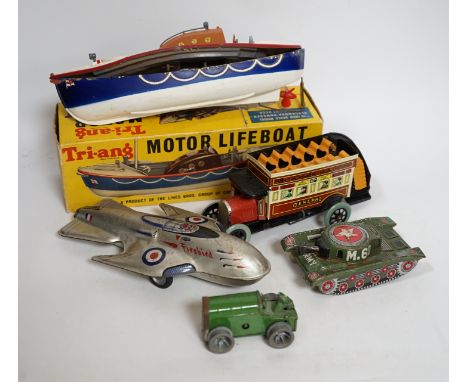 A collection of tinplate toys including cars, a fire engine, a Firebird jet plane, a Tri-ang lifeboat, an Tri-ang Minic tract