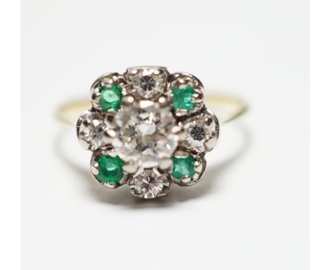 A yellow metal, diamond and emerald set flower head cluster ring, size P, gross weight 4 grams, the central diamond measuring