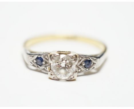 An 18ct and single stone diamond ring, with sapphire set shoulders, size N, gross weight 3.6 grams.