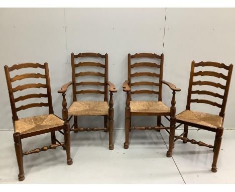 A set of four oak rush seat ladder back dining chairs, two with arms