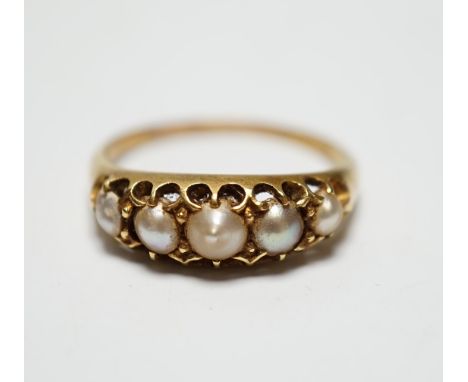 A Victorian yellow metal and graduated split pearl set half hoop ring, size S, gross weight 4 grams.