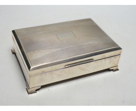 An Art Deco part engine turned silver rectangular cigarette box, Birmingham, 1937, 16.9cm.