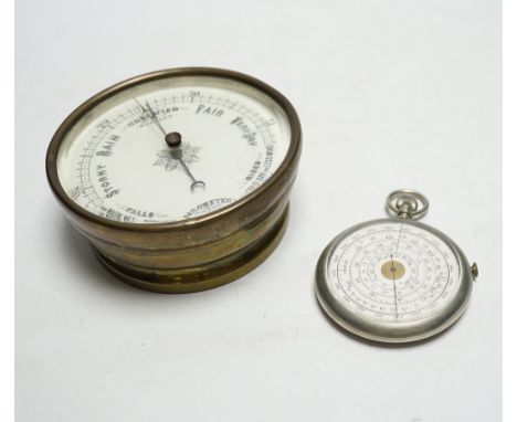 An aneroid barometer and a pocket calculator, calculator 11cm high