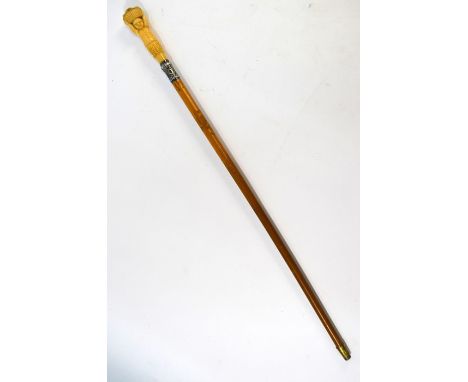 A 19th century malacca swagger stick, the ivory handle carved as a native figure supporting a basket of flowers, with white m