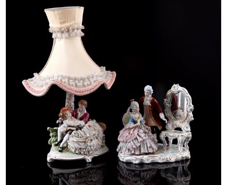 Porcelain sculpture group of a man and woman in traditional clothing near a mirror, 24 cm high (various damage) and a Dresden