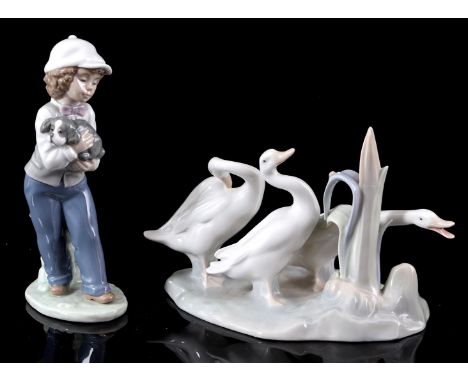 Lladro Spain porcelain figurine of ducks, 14 cm high and NAO Spain porcelain figurine of a boy with dog, 20 cm high