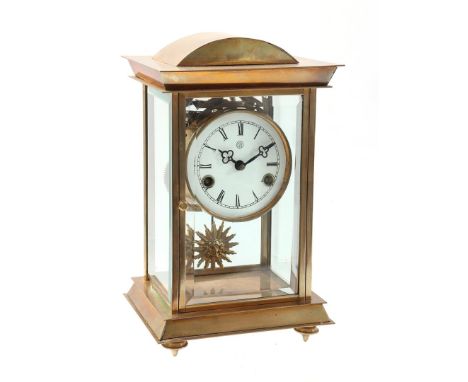 Table clock with enamel dial, sun pendulum, in brass case with facet cut glass, 33 cm high, 19.5 cm wide