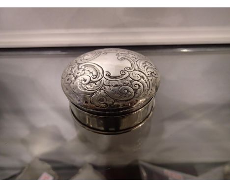 Sterling silver circular lidded box with embossed lid and gilt washed interior, Birmingham assay, 1902, 49g. Clear hallmark, 