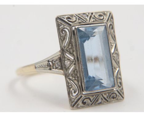 1920s cocktail ring, set with a large emerald-cut aquamarine surrounded with diamond chips, in a platinum setting and gold sh