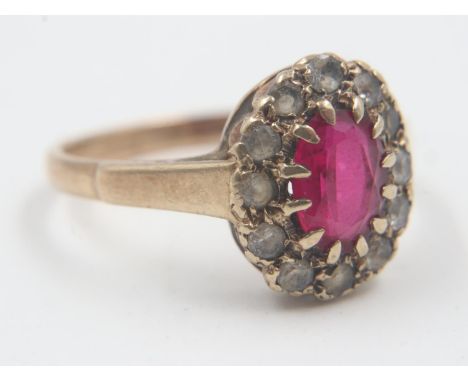 9ct gold stone-set cocktail ring, with a ruby surrounded by cubic zirconia, size M, 2.3g. UK P&amp;P Group 0 (£6+VAT for the 