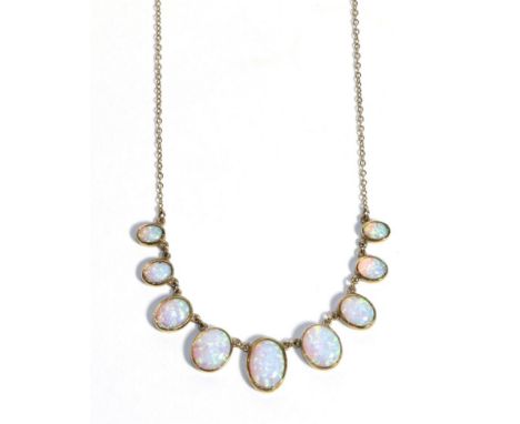 A 9 Carat Gold Synethtic Opal Necklace, graduated oval cabochon opals in rubbed over settings to a fine chain necklace, lengt