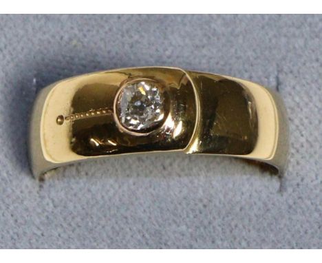 An 18 Carat Gold Solitaire Diamond Band Ring, an old cut diamond in a rubbed over setting, to a button-motif shank, estimated