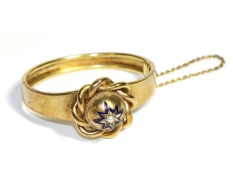A Victorian Pearl and Enamel Bangle, a central dome with a star set pearl within a blue enamel frame to a scroll border, to a