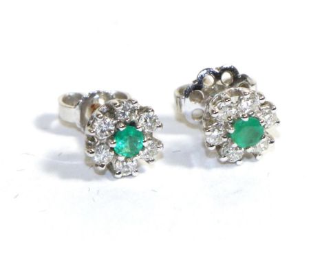 A Pair of 18 Carat White Gold Emerald and Diamond Cluster Earrings, a round cut emerald within a border of six round brillian