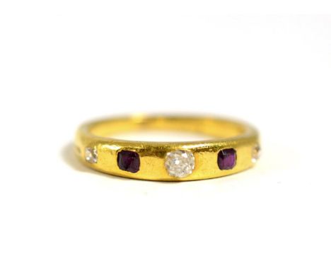 A Ruby and Diamond Band Ring, inset with three graduated old cut diamonds spaced by two step cut rubies, total estimated diam