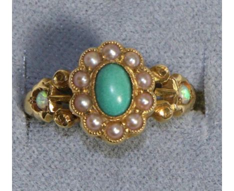 An 18 Carat Gold Turquoise, Opal and Seed Pearl Ring, an oval cabochon turquoise in a rubbed over setting, within a border of