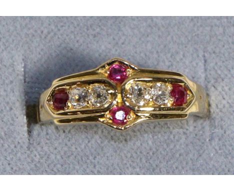 An 18 Carat Gold Diamond and Ruby Ring, four old cut diamonds spaced by round cut rubies in a carved setting, total estimated