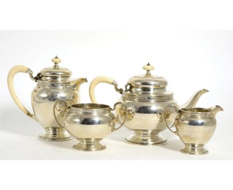 A George V Silver Four Piece Tea Service, Mahoah Rhodes, Sheffield, 1930, circular with a band of engraved decoration to rim,