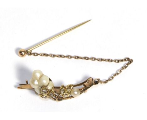 A Baroque Pearl and Diamond Brooch, a scroll bar with rose cut diamond leaf clusters with baroque pearl 'berries', measures 1