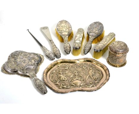 A Late Victorian Silver Dressing Table Set, Samuel Jacob, London 1898, decorated with a courting couple in 18th century dress