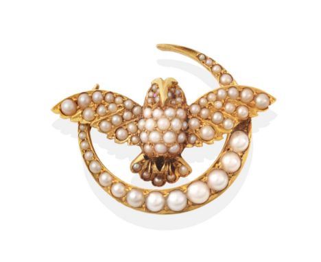A Seed Pearl Owl and Crescent Brooch, modelled with outstretched wings and ruby set eyes, within a crescent, measures 2.5cm b