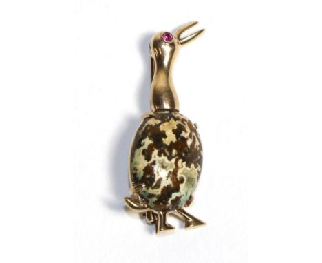 A Jasper and Ruby Bird Brooch, modelled as an abstract bird with a jasper body and a ruby set eye, measures 3.8cm by 1.5cm Th