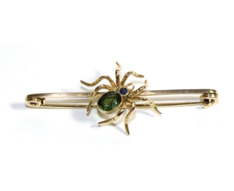 A Gem Set Spider Brooch, realistically modelled with an oval cut green tourmaline abdomen and a round cut sapphire body, to a