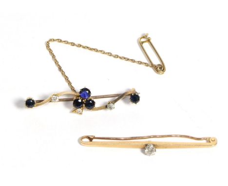 A Sapphire and Diamond Brooch, three round cut sapphires in a clover formation with an old cut diamond stem, to a scroll knif