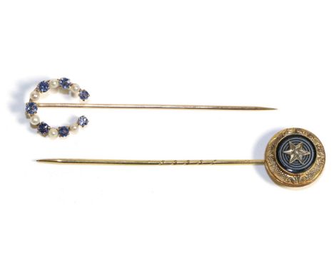 A Sapphire and Seed Pearl Horseshoe Stick Pin, formed of alternating round cut sapphires and seed pearls, measures 1.5cm by 1