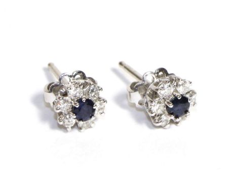 A Pair of Sapphire and Diamond Cluster Earrings, a round cut sapphire within a border of six round brilliant cut diamonds, to