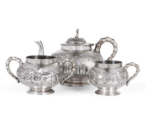 An Indian White Metal Three Piece Tea Service, late 19th/early 20th century, decorated in relief with Indian countryside scen