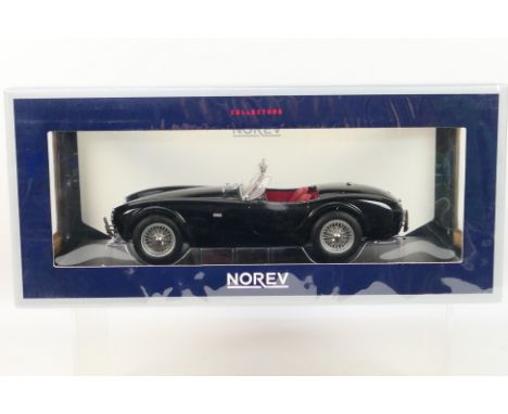 Norev - A boxed Norev #182754 1:18 scale AC Cobra 289 1963. The model in black appears to be in Mint condition, housed within