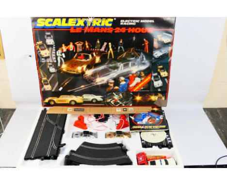 Scalextric - A boxed vintage Scalextric C664 Le Mans 24Hr set. The set contains, two Porsche 911 Turbos in silver and gold, p