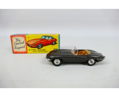 Corgi Toys - A boxed Corgi Toys #307 E-Typoe Jaguar. The model in grey with with tan interior and spun hubs. The model is mis