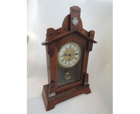 A late 19th century part walnut case mantel clock in the Gothic style