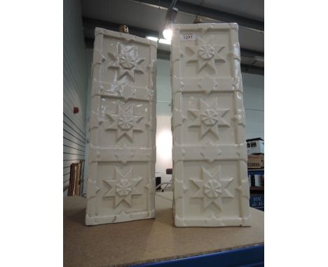 A pair of modern ceramic table lamps designed as white embossed towers