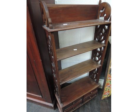 An Eastern style hardwood wall shelf having fretwork sides and drawer base