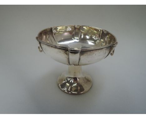 A silver tazza having ring handles tapered pedestal foot and stepped decoration, Birmingham 1906, William Hutton & Sons,  178
