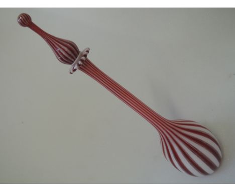 A Venetian style candy stripe decanter having red and opaque glass of tear drop design