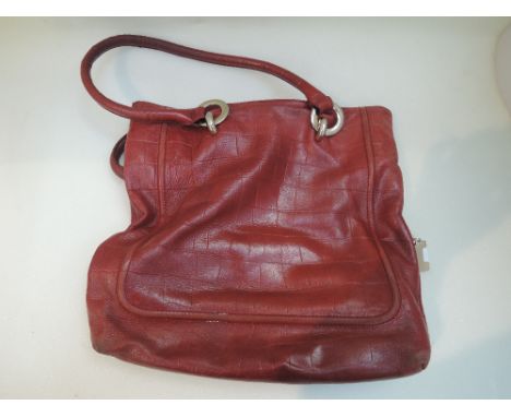 A vintage red leather shoulder bag by Jaeger having magnetic clasp