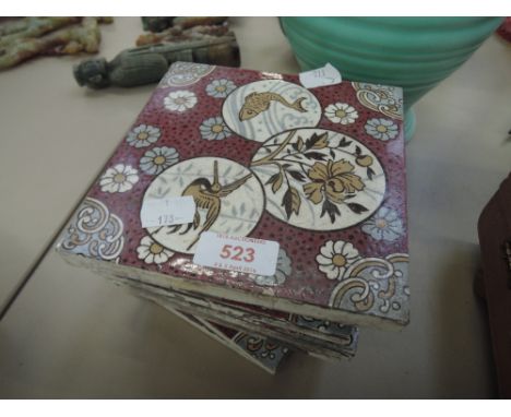 Eight Victorian ceramic tiles in the Minton style having naturalistic decoration